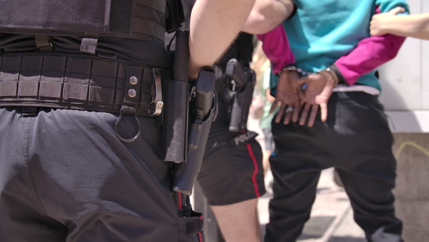 Criminal being arrested by police on the street