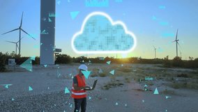 A mechanical engineer working on a laptop at a wind turbine farm, using cloud technology to monitor performance. Modern renewable energy and innovation concept - Powered by Shutterstock - Get 15% off with code: PIKWIZARD15