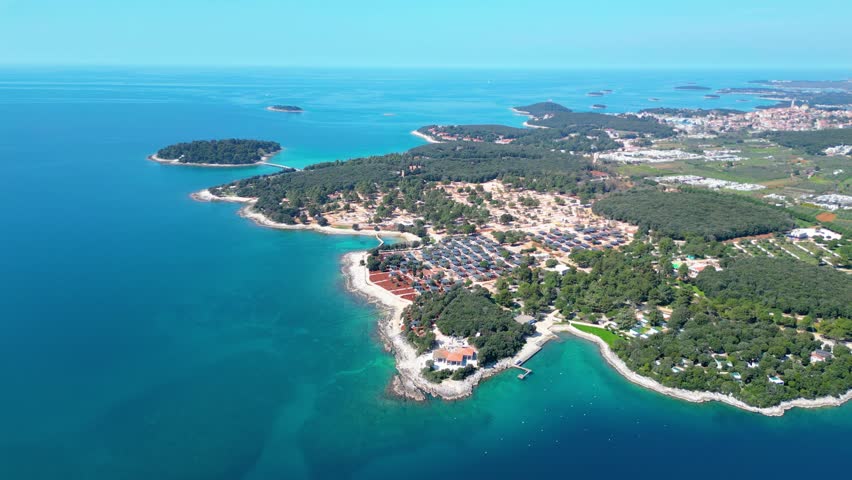 Aerial photo of the stunning Limski Kanal and Camping Koversada near Vrsar, Croatia. The landscape features lush greenery, crystal-clear turquoise waters, and winding coastline — a true Adriatic