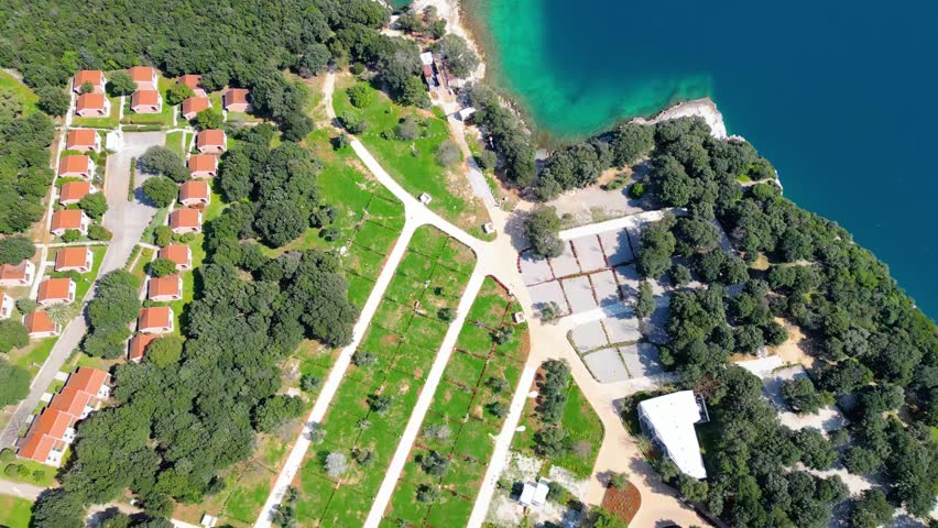 Aerial photo of the stunning Limski Kanal and Camping Koversada near Vrsar, Croatia. The landscape features lush greenery, crystal-clear turquoise waters, and winding coastline — a true Adriatic