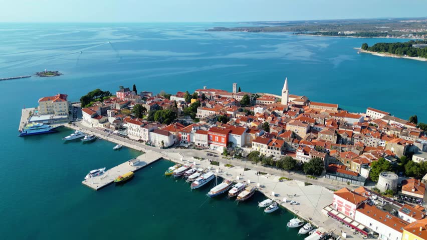 Aerial view of Poreč (Porec), Croatia, showcasing the charming old town, vibrant coastline, and the nearby island of Sveti Nikola. The stunning Zelena Laguna area adds to the beauty turquoise waters