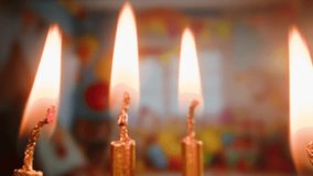 Woman kid child Blowing candles on birthday cake macro, close up of some unlit candles and just one lit candle after blowing out the cake - Powered by Shutterstock - Get 15% off with code: PIKWIZARD15