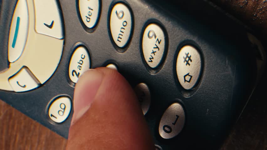 Man arm holding phone cellphone, vintage retro mobile phone, text message sms.