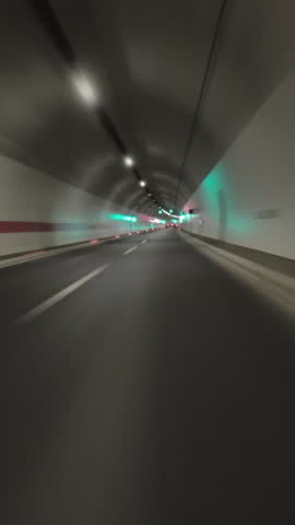 POV fast car driving on the highway at night and in the tunnel, timelapse. Vertical video