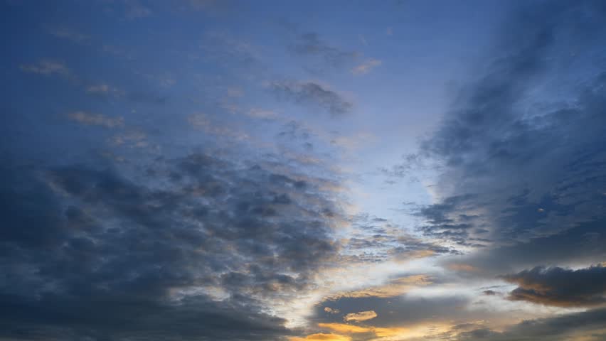 A time-lapse of the sunset, where the vibrant play of colors creates a romantic backdrop against the moving clouds. Sky cycles and air concept. Timelapse. 4K.
