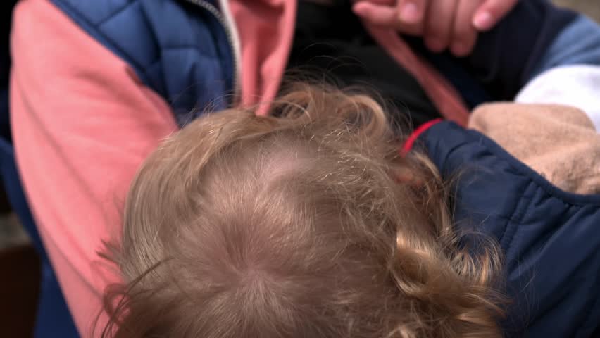 Mother Breastfeeding Her Toddler in a Park on a Sunny Day