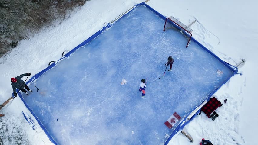 Top down view of girls playing hockey outdoors