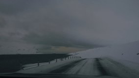 Winter drive through desolate icy roads surrounded by snow-covered Arctic tundra in Iceland - Powered by Shutterstock - Get 15% off with code: PIKWIZARD15
