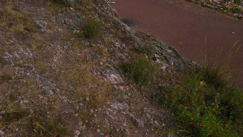 Reveal shot of Cusco airport runway, city, and mountains under a sunny sky, Peru.