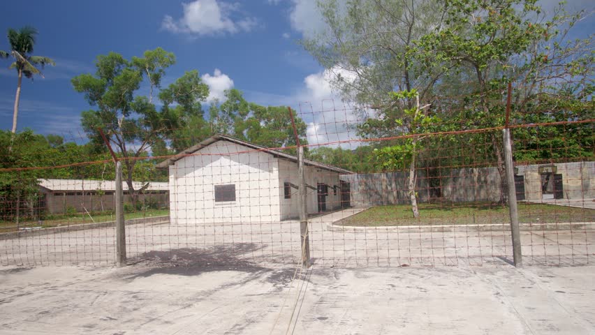 Trại Phú Bình, fences and walls stood high, beneath a deep blue sky