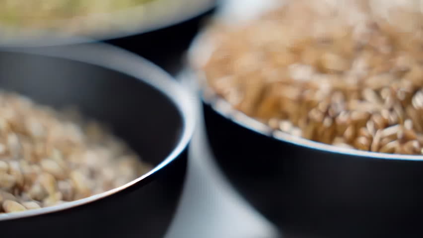 A variety of different colored Raw healthy grain food, Various grains, cereals, beans, legumes are rotated in wooden decoration for advertisement concept. High protein products, Healthy vegan food.