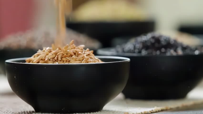 A variety of different colored Raw healthy grain food, Various grains, cereals, beans, legumes are rotated in wooden decoration for advertisement concept. High protein products, Healthy vegan food.