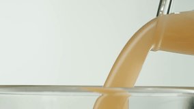 Apple pear juice or cider is pouring from a bottle into a glass. Fresh drink with apples and pear on an old kitchen table.  - Powered by Shutterstock - Get 15% off with code: PIKWIZARD15