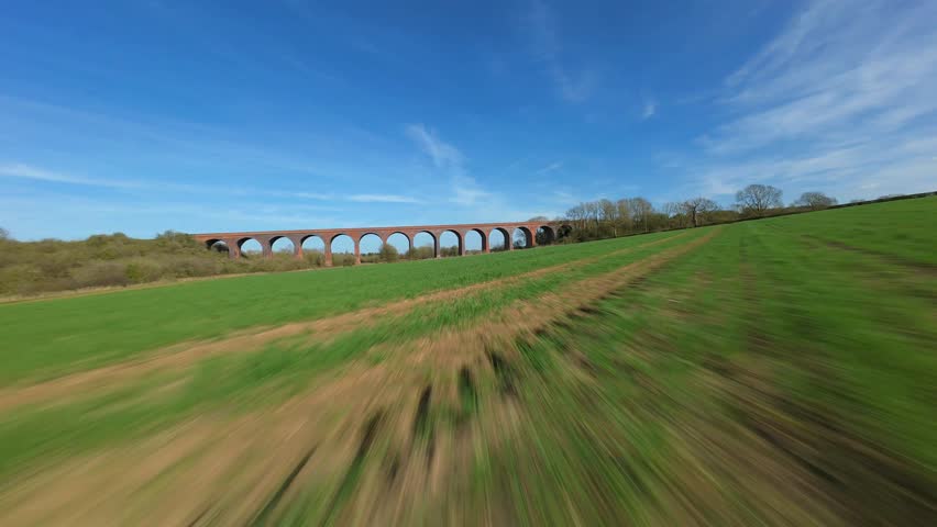 High speed FPV drone footage flying through an old viaduct in rural England.