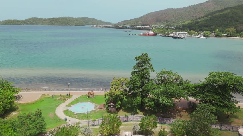 A drone’s aerial view reveals the stunning Chaguaramas boardwalk and Williams Bay on the coast of Trinidad in the Caribbean.