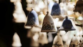 Slow motion of swinging ceramic bells glowing softly at Riga Christmas market - Powered by Shutterstock - Get 15% off with code: PIKWIZARD15