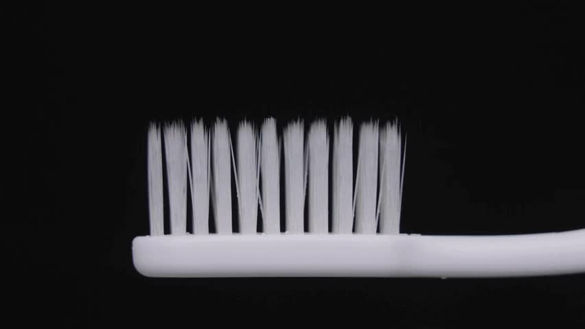 healthcare, Close up shot of toothpaste being put on toothbrush. modern toothbrush handle and bristles with activated paste fluoride active carbon