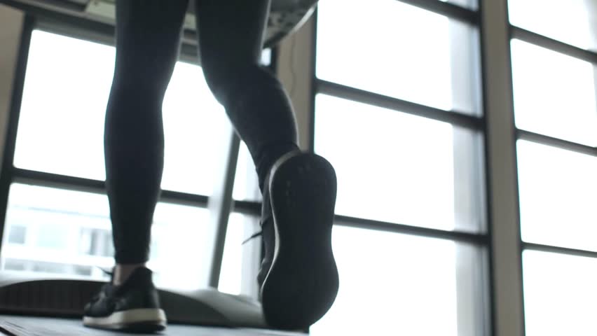 Woman and man athetic walking on treadmill in fitnessHealthly,exercise,city lift style conceptSlow motion footage