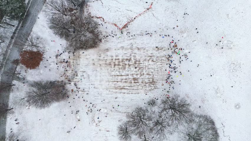 Aerial top down shot of people sledding in Piedmont Park Atlanta on January 10th 2025.