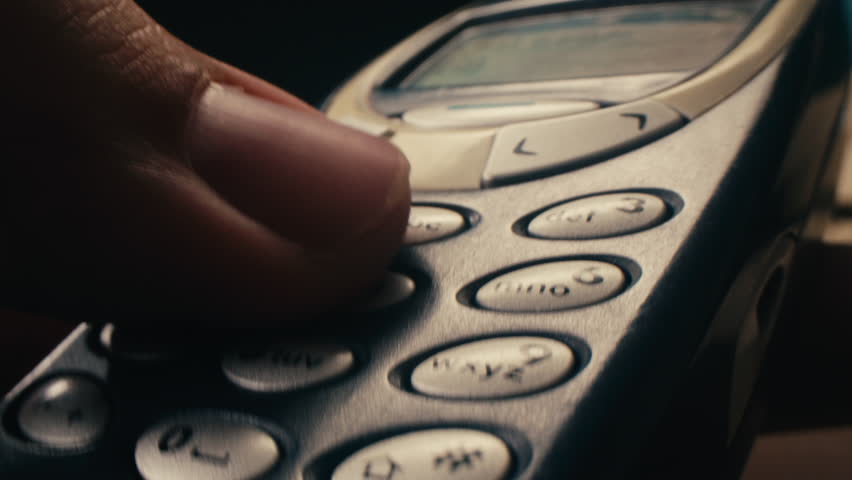 Man arm holding phone cellphone, vintage retro mobile phone, text message sms.