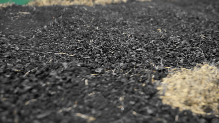 A pile of shredded tires being sorted and recycled in an industrial facility.
