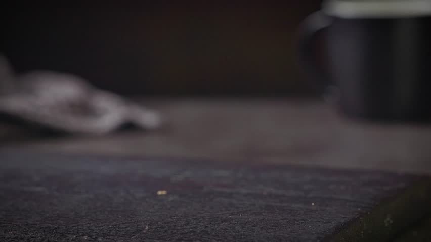 cook put burger bread bun on black wooden cutting board and put sauce on bread bun, food closeup