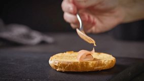 cook put burger bread bun on black wooden cutting board and put sauce on bread bun, food closeup - Powered by Shutterstock - Get 15% off with code: PIKWIZARD15