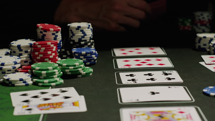 Game of poker in casino, taking place with poker chips and cards on a green table, gambling place, roulette jack pot. 