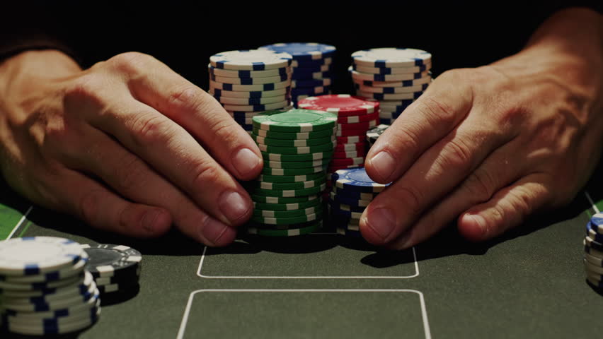 Game of poker in casino, taking place with poker chips and cards on a green table, gambling place, roulette jack pot. 