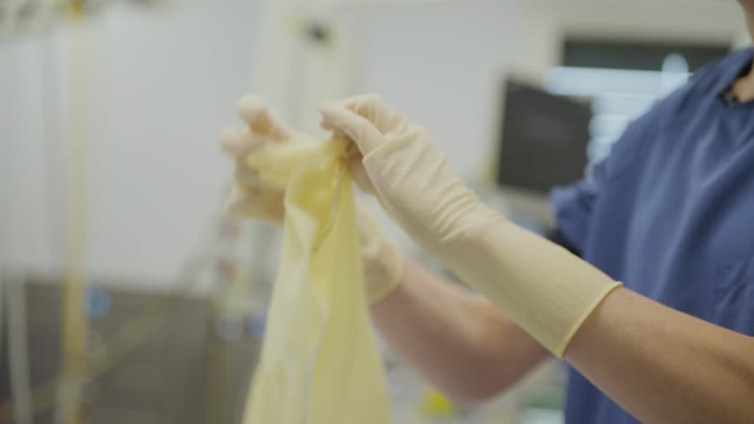 Footage showing hospital staff discarding clean or unused medical clothing and gloves, highlighting unnecessary waste in healthcare.