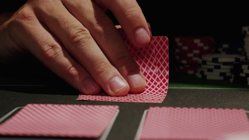 Game of poker in casino, taking place with poker chips and cards on a green table, gambling place, roulette jack pot. 