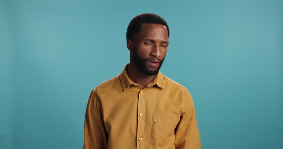 Black man, face and shrug for confusion in studio, uncertain and memory fail or crisis on background. Male person, portrait and fake news or gesture for question, why and clueless doubt for decision
