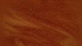 Ink water. Blurred glitter dust. Red brown color sparkling particles texture smoke splash paint fluid on dark black abstract art background. - Powered by Shutterstock - Get 15% off with code: PIKWIZARD15