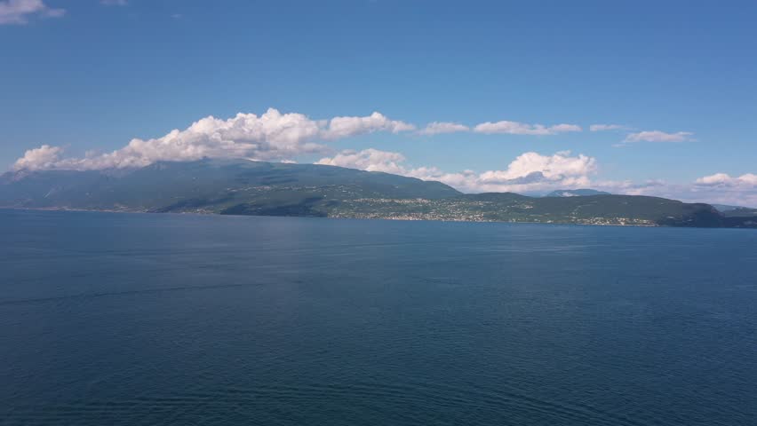 Aerial view of Isola del Garda, Lake Garda, Italy. Take a boat trip to Isola del Garda, an enchanting island with a historic villa, beautiful gardens, and stunning views of Lake Garda and the Alps.