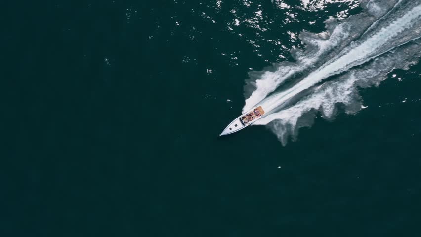 Fast Movement of a Big Luxury Grey Speed Boat: 4K Drone Video with Aerial View Over Water in Italy