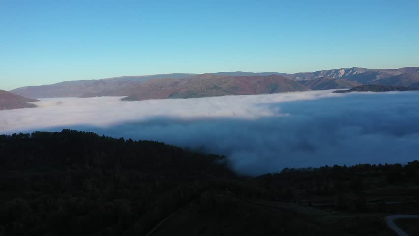  Aerial view of misty morning, flying over clouds in the valley