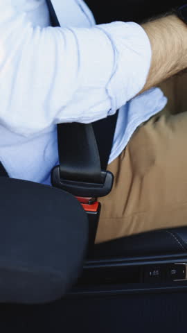 Vertical Video of Driver Fastening Seatbelt In Car. Man Car Lap Buckling Seat Belt Inside In Vehicle Before Driving. Male Hand Fastening Car Safety Seat Belt. Protection Road Safety Snap Driving.
