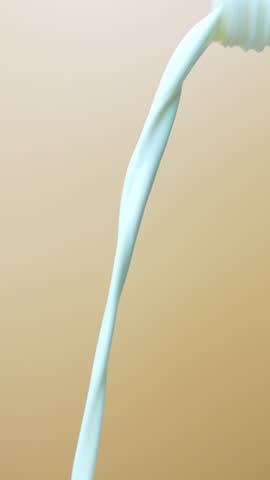 smooth stream of milk being poured from a plastic bottle mid-flow against a soft beige background, minimal and clean composition highlights freshness and fluid motion.