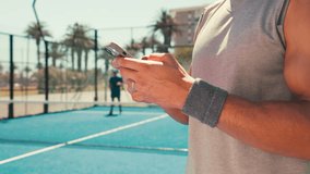 Sports, hands and man with phone on tennis court for social media, online chat and internet. Athlete, fitness and person on smartphone on break relax after training, exercise and workout for game - Powered by Shutterstock - Get 15% off with code: PIKWIZARD15