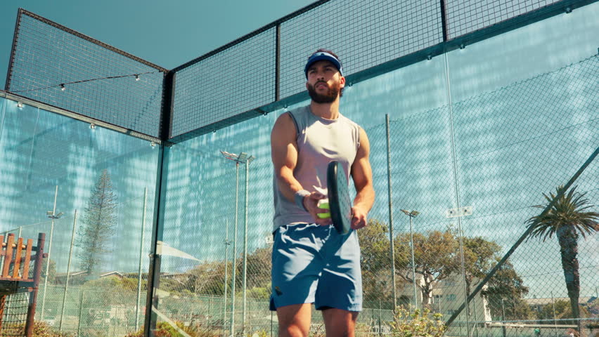 Sports, tennis court and man with ball serve for game, match and competition outdoors. Fitness, athlete and person with padel for training, exercise and workout for tournament, challenge or practice
