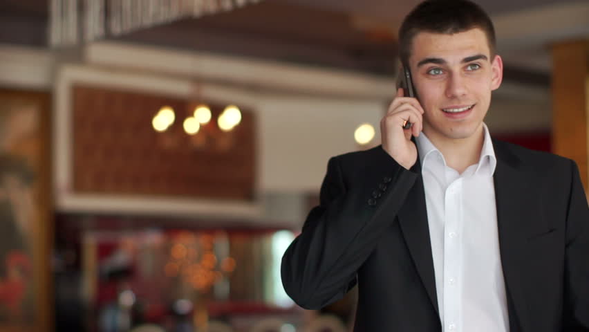 Businessman speaking by phone and smiling