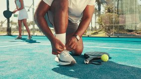 Padel tennis, hands and man tying shoes to prepare for training, exercise and match on court outdoor. Athlete, tie sneakers and start fitness, game and getting ready to workout for sports with ball - Powered by Shutterstock - Get 15% off with code: PIKWIZARD15