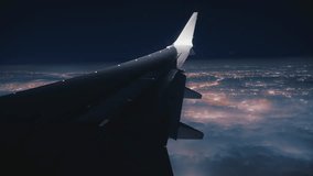The breathtaking view from an airplane window during nighttime captures the dazzling city lights shimmering as the plane makes its descent - Powered by Shutterstock - Get 15% off with code: PIKWIZARD15
