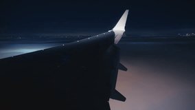 Witnessing the stunning views that can be seen from an airplane window during a nighttime landing, with beautiful city lights shining brightly - Powered by Shutterstock - Get 15% off with code: PIKWIZARD15