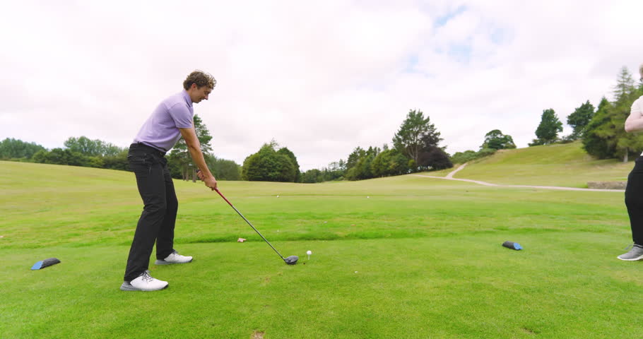 Male players playing golf, one player knocks ball out on a course, copy space. sport, lifestyle, golf and activity