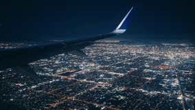 The breathtaking view from an airplane window at night displays the sparkling city lights just moments before the plane descends for landing - Powered by Shutterstock - Get 15% off with code: PIKWIZARD15