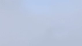 Drone footage showing a large-scale industrial complex emitting smoke, contrasted with nearby wind turbines – symbolizing the energy transition. - Powered by Shutterstock - Get 15% off with code: PIKWIZARD15