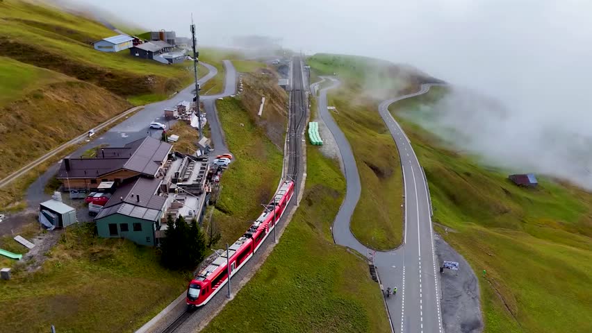 Red train in Swiss mountains during the autumn (Top View).