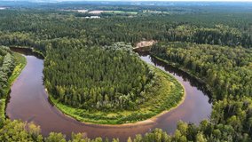 Aerial view of Ancient Sandstone Cliffs (Erglu Klintis) and Devonian Rock Formations Along a River Valley in Gauja National Park, Latvia - Powered by Shutterstock - Get 15% off with code: PIKWIZARD15