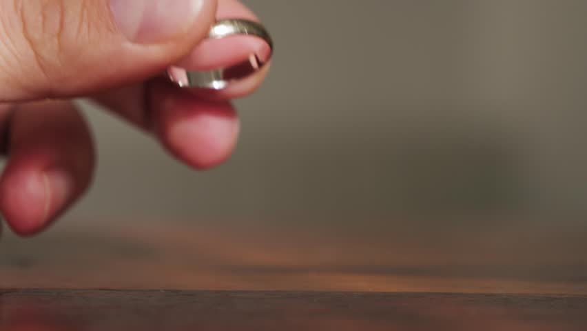 A feeling of love that fades. The man removes wedding ring from finger. Adultery and divorce concept. High quality 4k footage